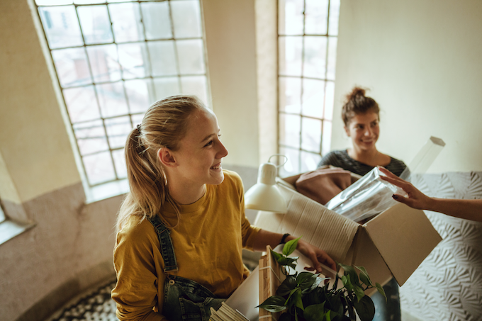 girls climbing stairs holding boxes